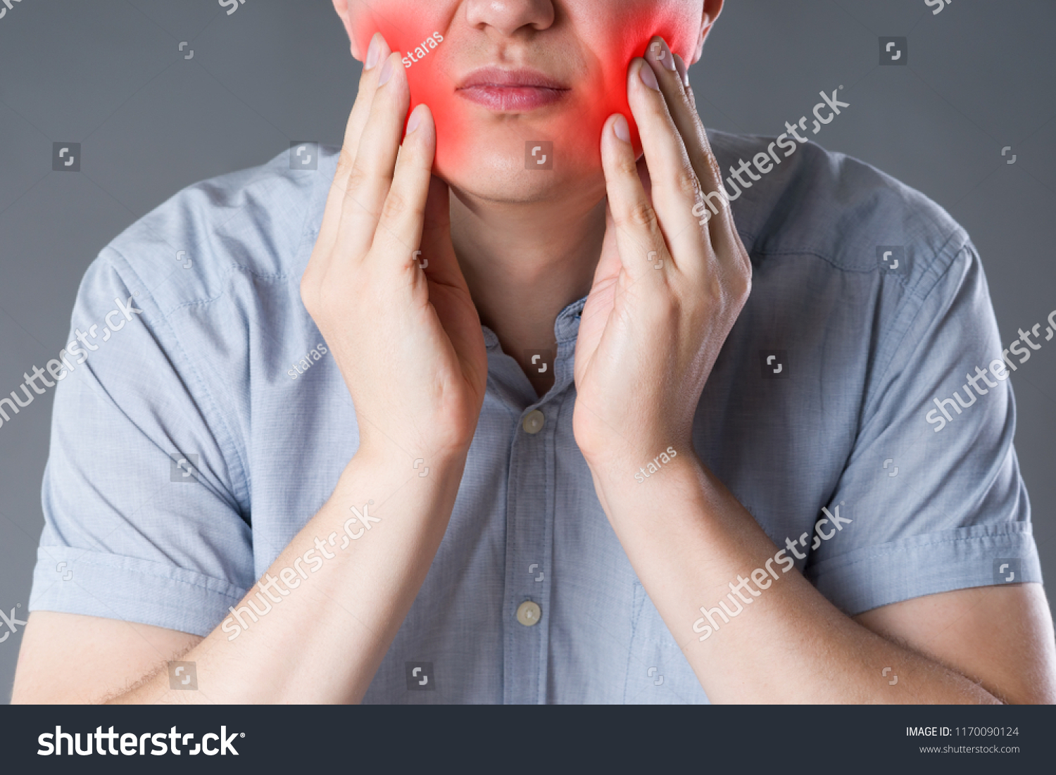 Wisdom teeth, man suffering from a toothache on gray background, painful area highlighted in red #1170090124