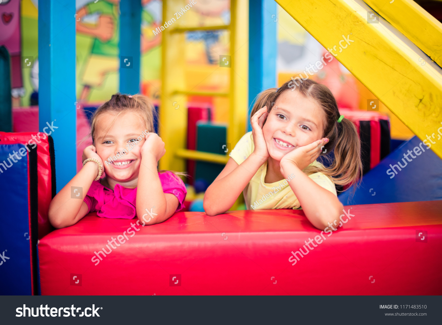 We are happy kids. Two little smiling girl in playground looking at camera. Space for copy. #1171483510