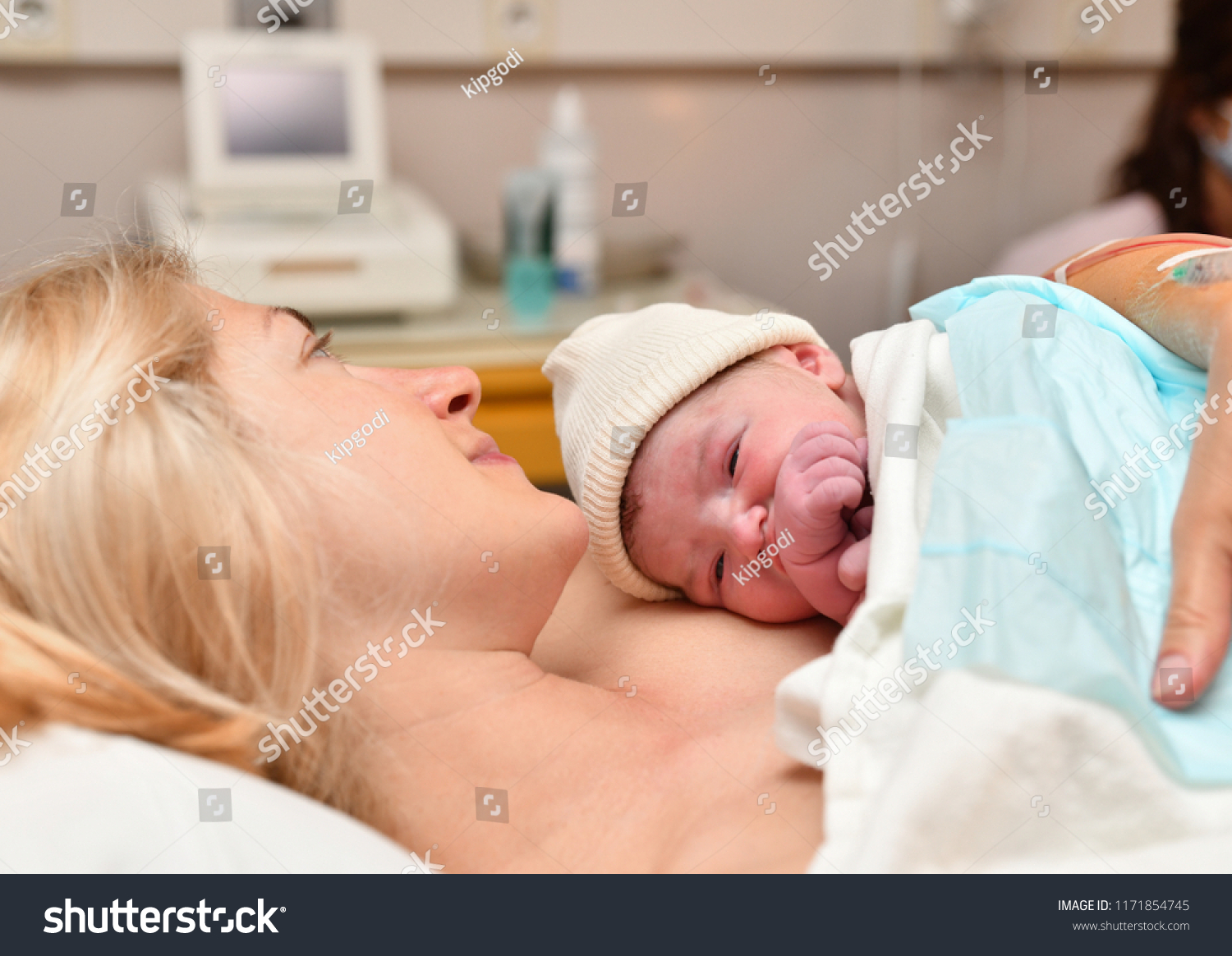 Mom and newborn baby skin to the skin after birth in the hospital #1171854745