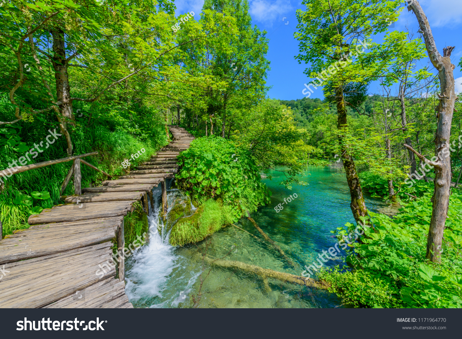 Amazing touristic wooden pathway in the colorful deep forest with clean lakes and spectacular waterfalls, Plitvice National Park, Croatia #1171964770