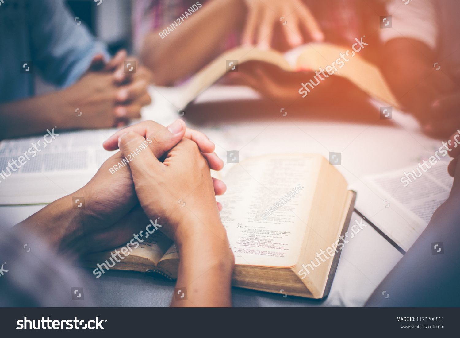 Christians are congregants join hands to pray and seek the blessings of God, the Holy Bible. They were reading the Bible and sharing the gospel with copy space. #1172200861