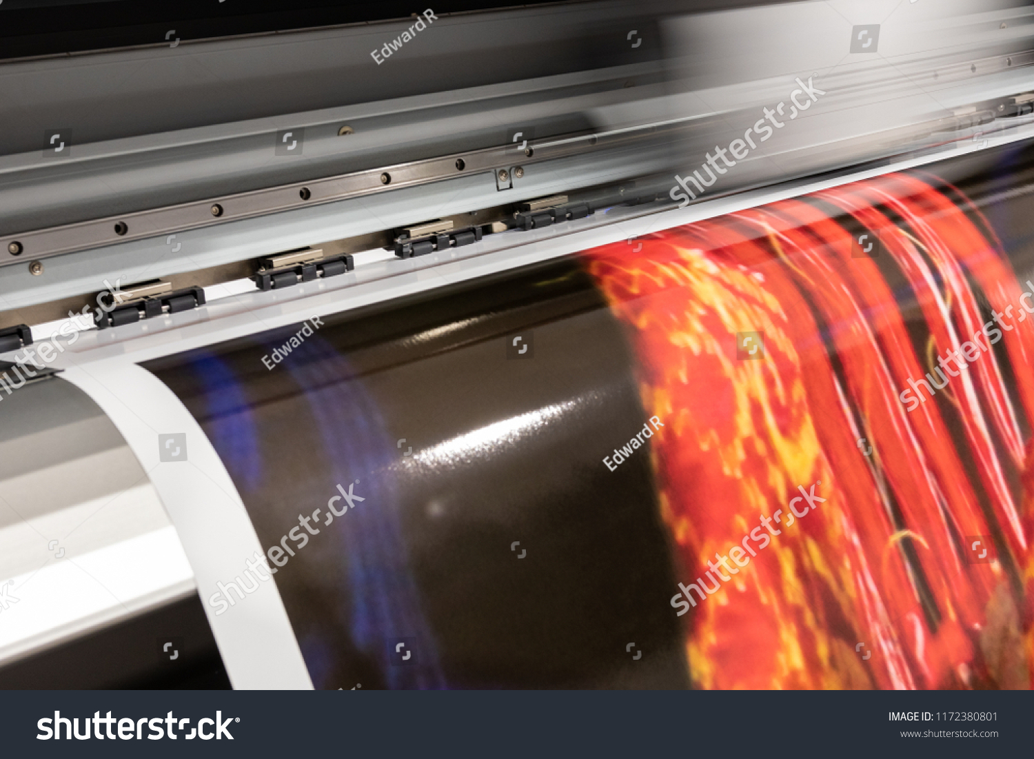 Massive print head processing an oversized glossy color sample before initiating customer orders. #1172380801