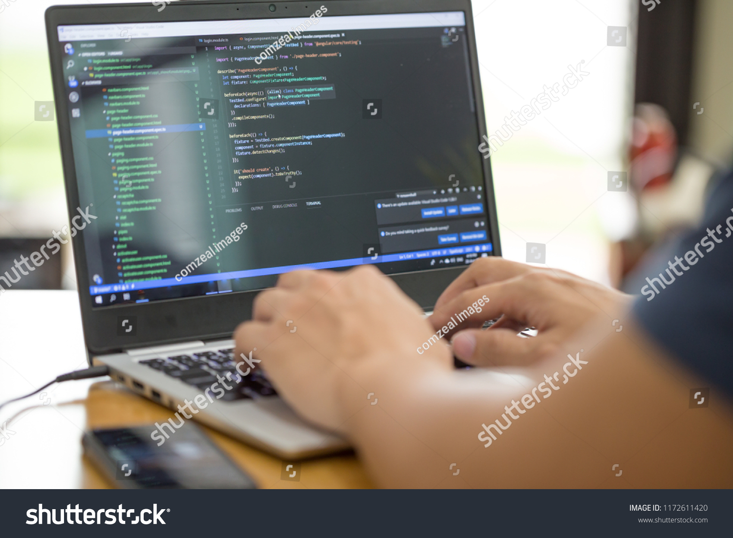 Freelance programmer or developer working at home and typing source code with laptop #1172611420
