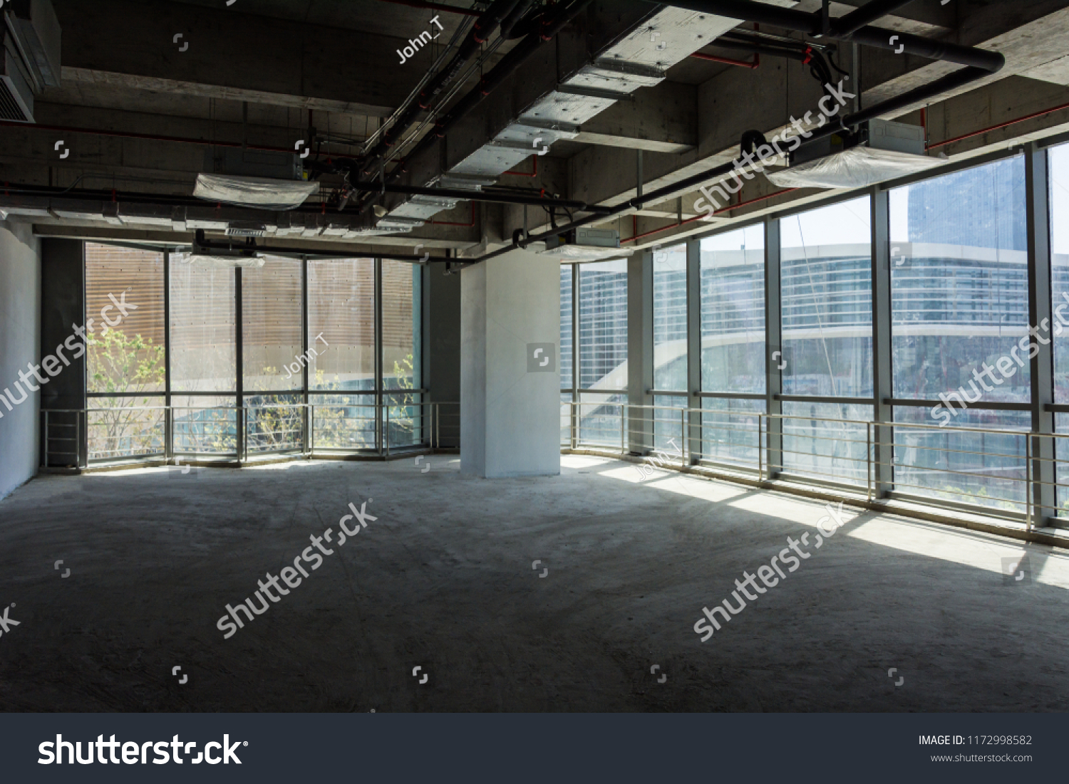 Unfinished interior of business center under construction in grey colours #1172998582