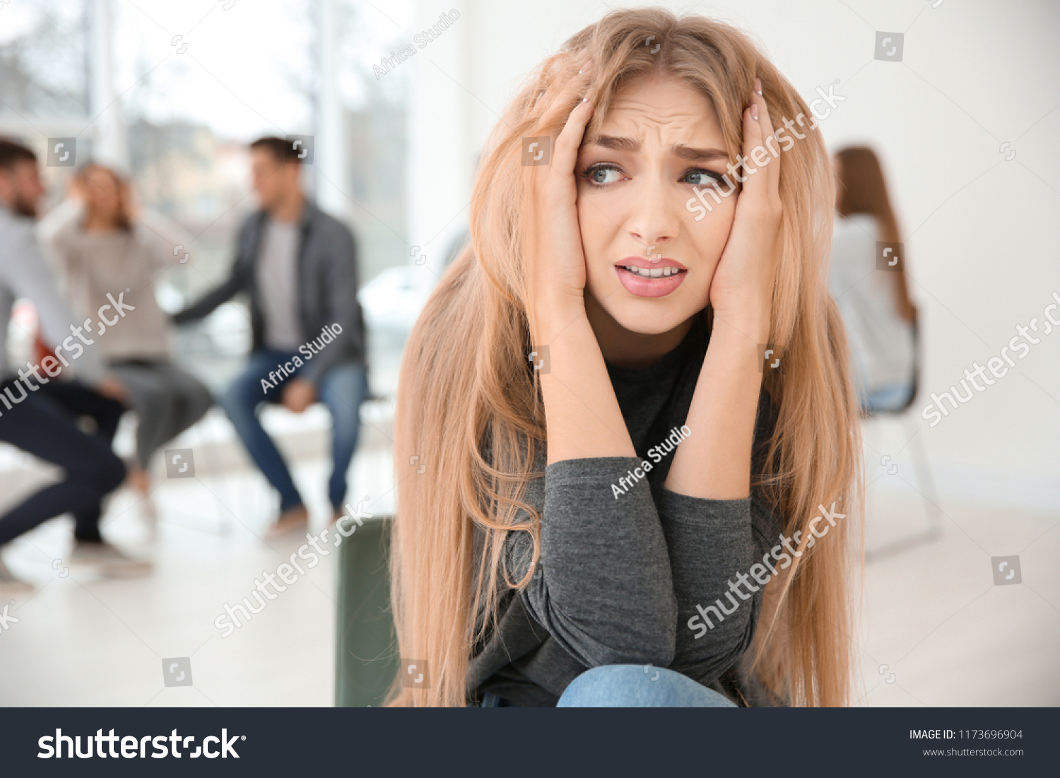 Stressed woman during group therapy, indoors #1173696904