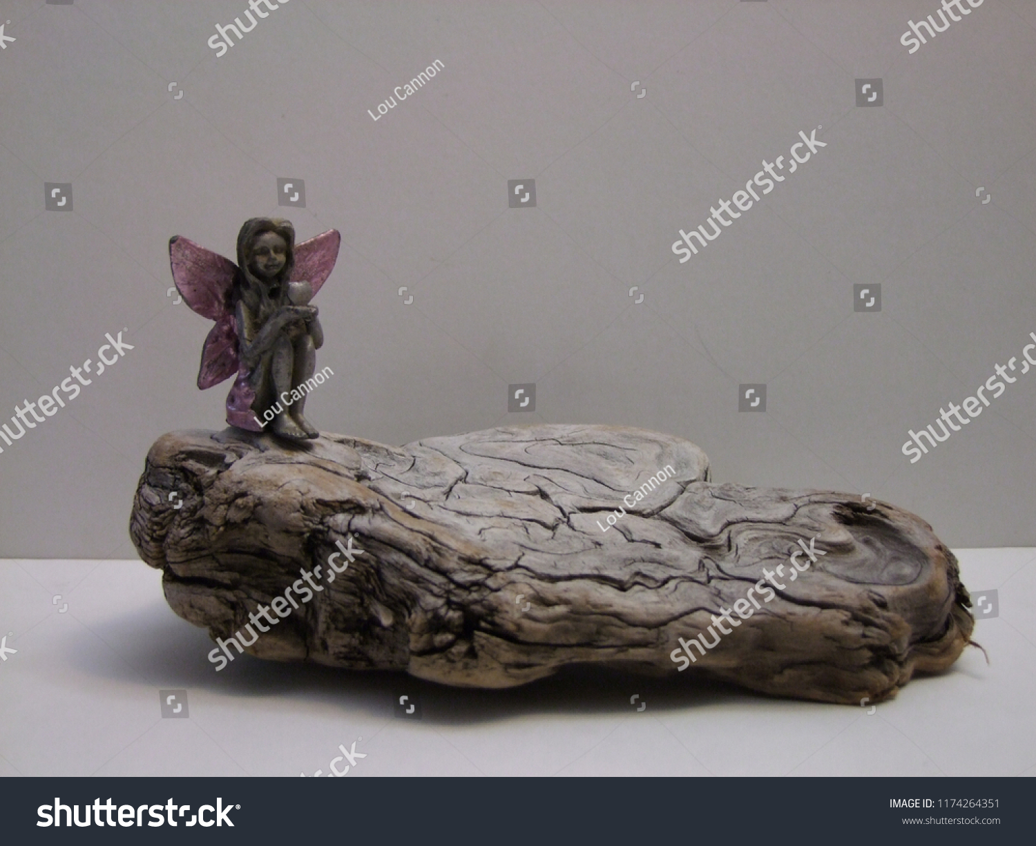Sweet Pewter Angel Perched sitting on an old piece of drift wood #1174264351