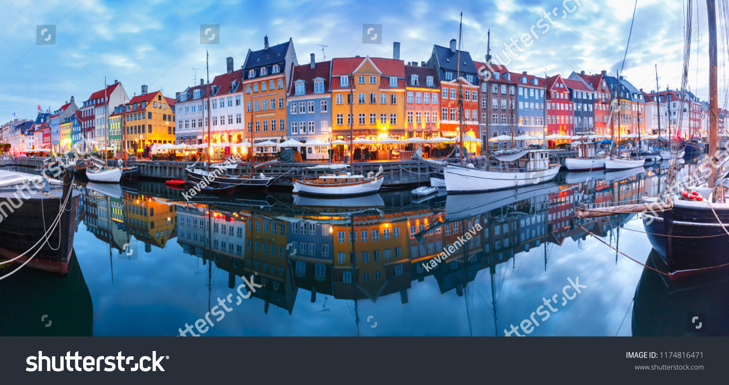 Panorama of north side of Nyhavn with colorful facades of old houses and old ships in the Old Town of Copenhagen, capital of Denmark. #1174816471