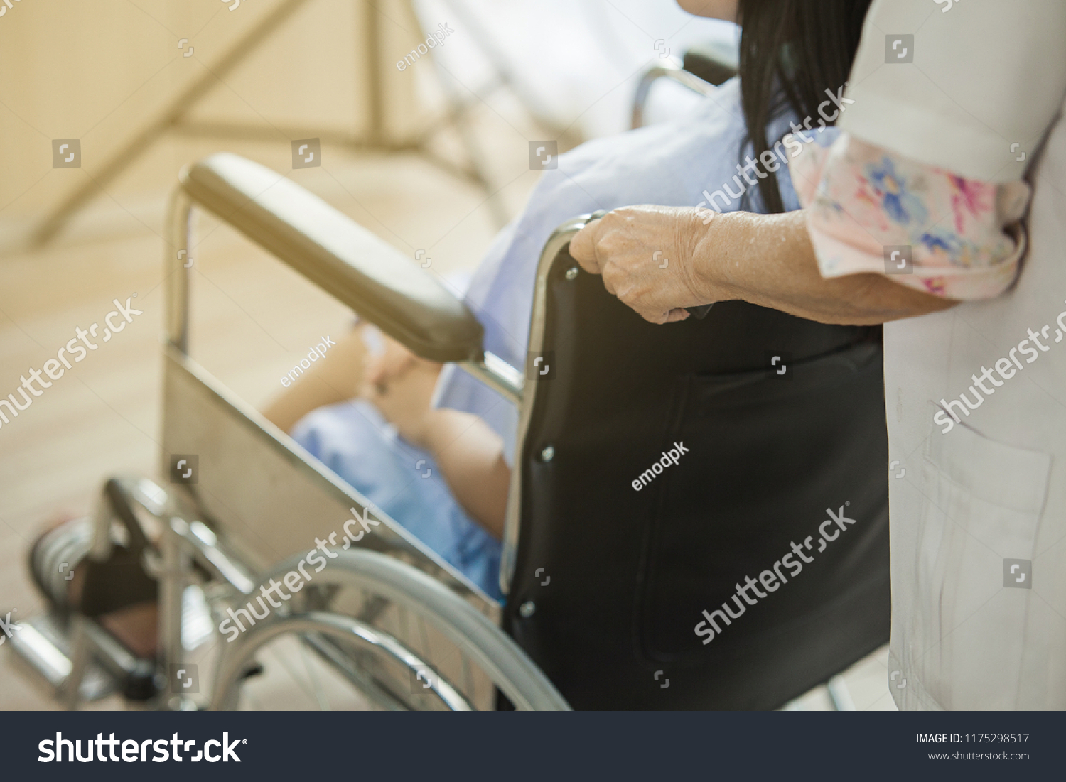 Female doctor pushing injury woman her bone crash the leg, The doctor helathcare recovery the girl sit on wheelchair #1175298517