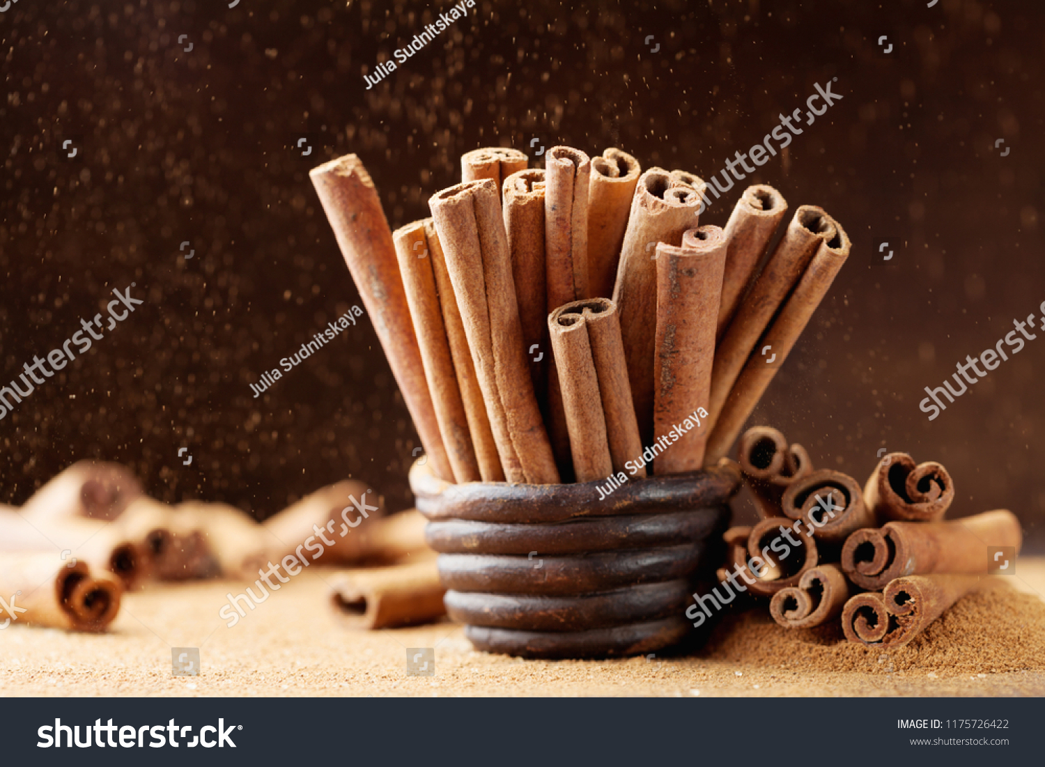 Heap of cinnamon sticks and ground cinnamon with dust effect. Aromatic spice. #1175726422