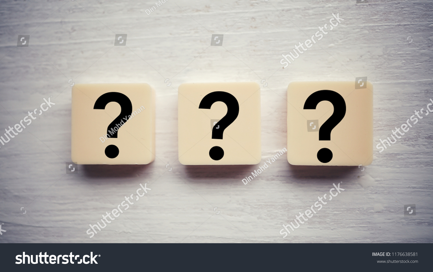 Question mark on alphabet block. Question mark over wooden background #1176638581