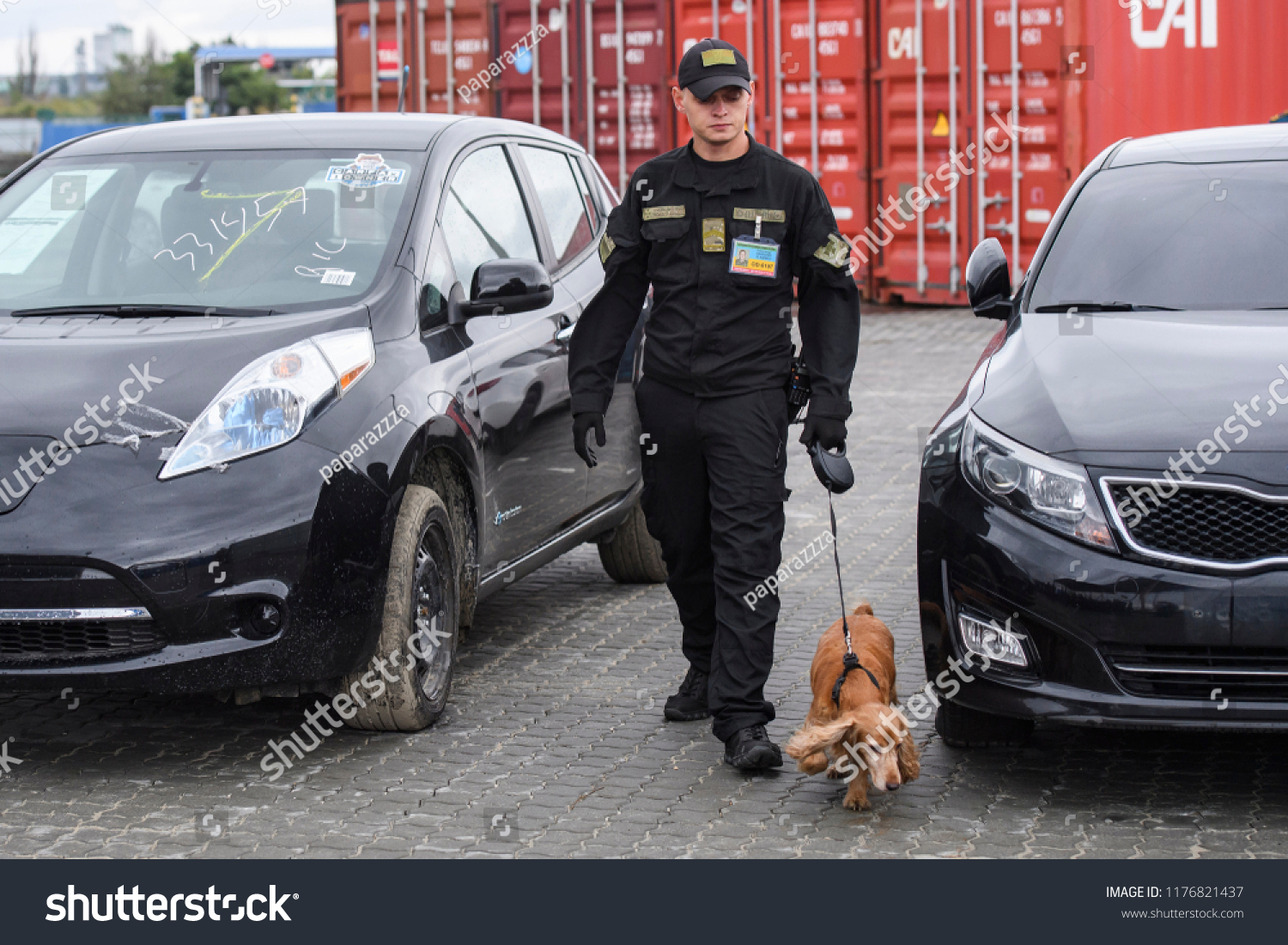 A customs officer with dog checks a car at a custom in the port of Odesa, Ukraine. 10-09-2018 #1176821437