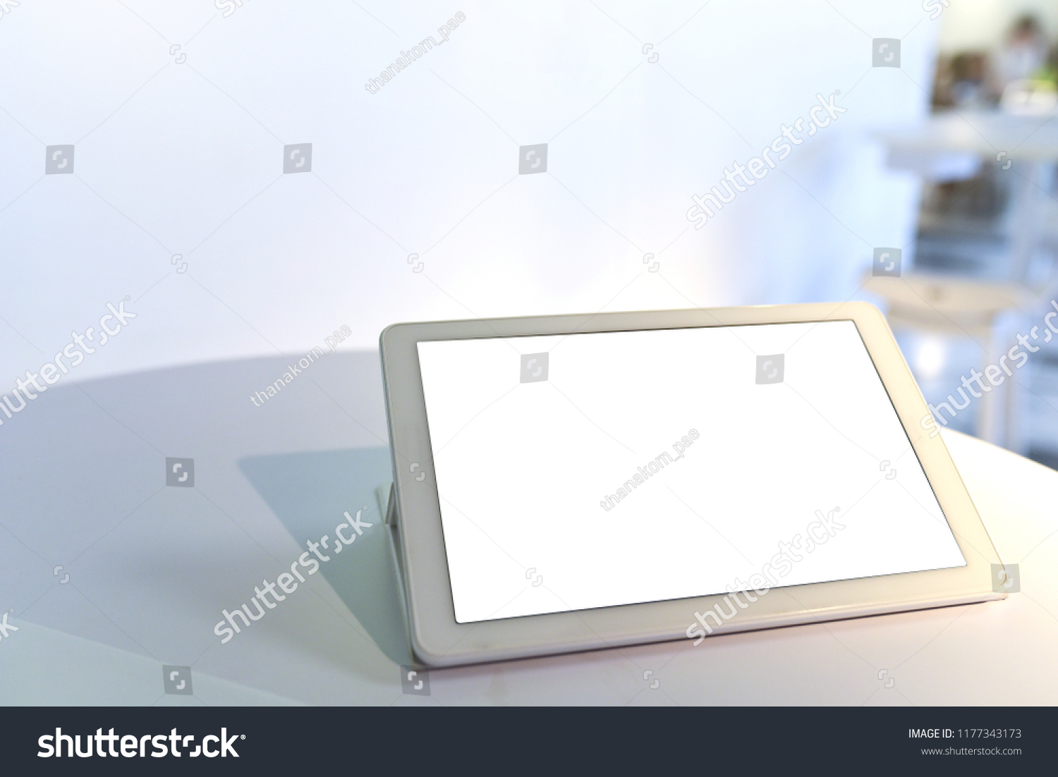 White portable smart tablet device and bright blank monitor screen place on the table in restaurant to order some items using for UX UI design application or business advertising e-commerce copy space #1177343173