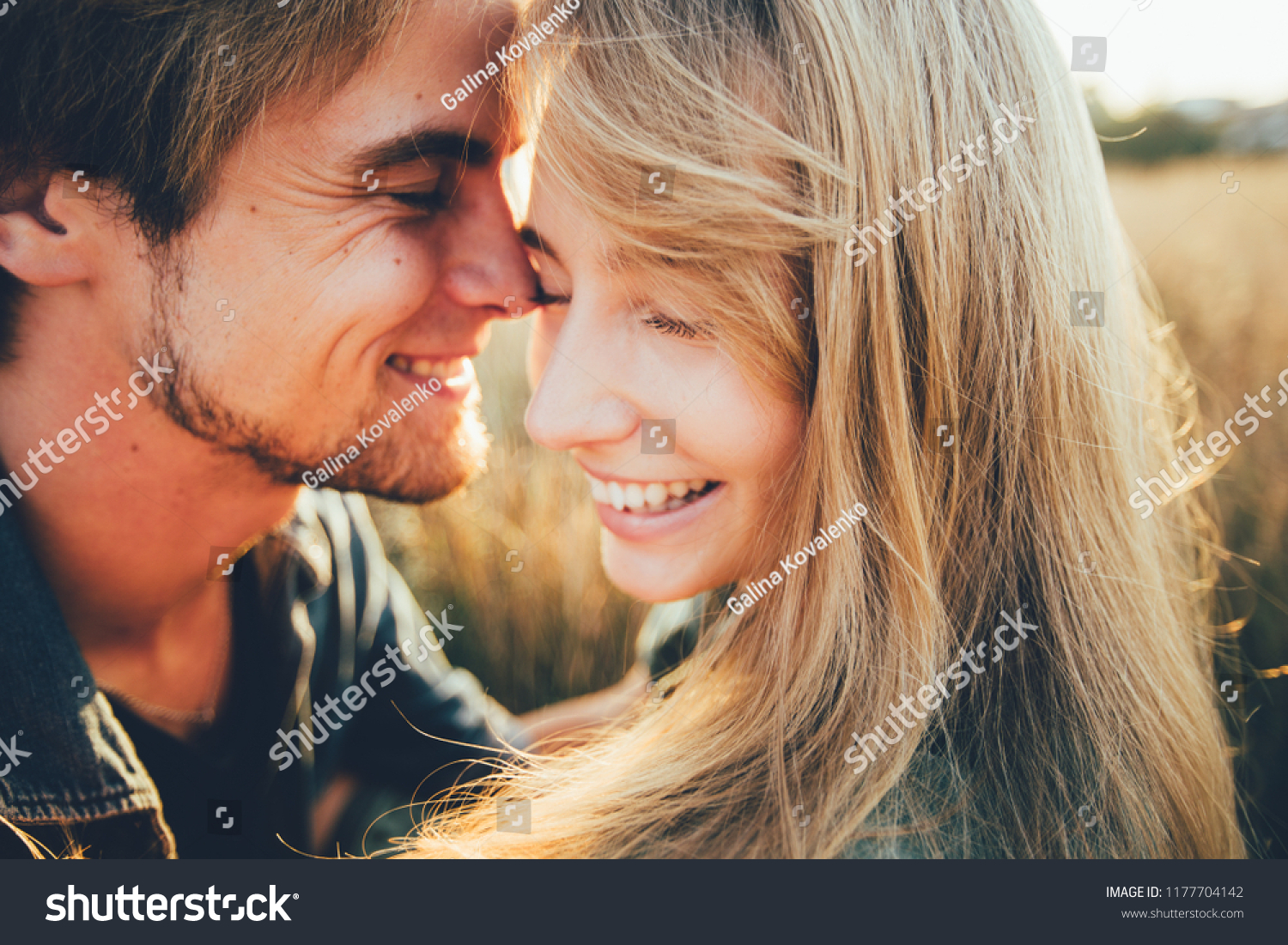Young happy couple hugging and laughing. Space for text. Close-up. #1177704142