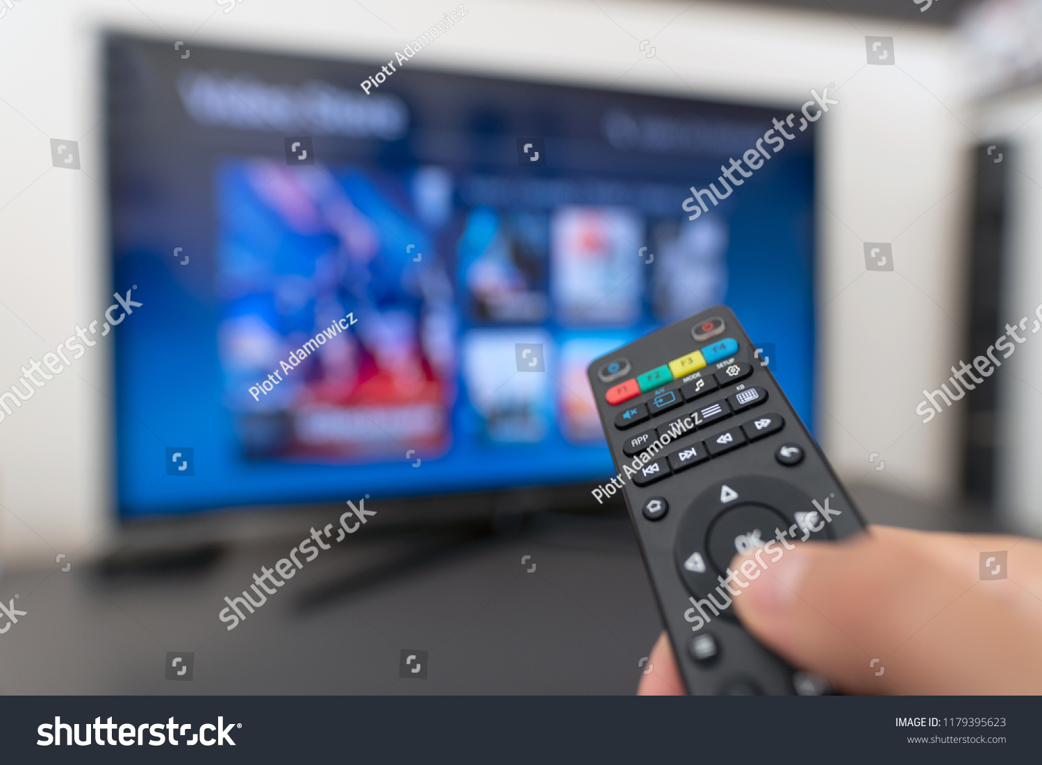 Multimedia streaming concept. Hand holding remote control. Video on demand #1179395623