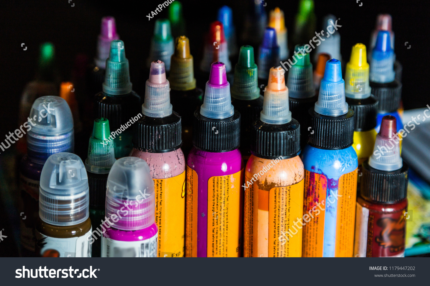 many professional bottles with colored ink for tattoos. tattoo parlor #1179447202
