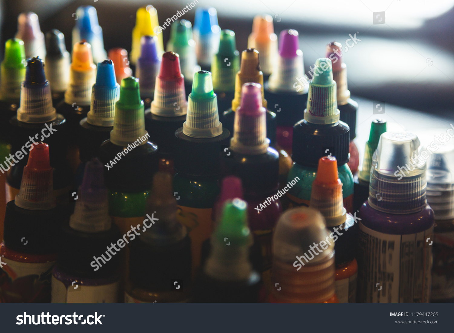 many professional bottles with colored ink for tattoos. tattoo parlor #1179447205
