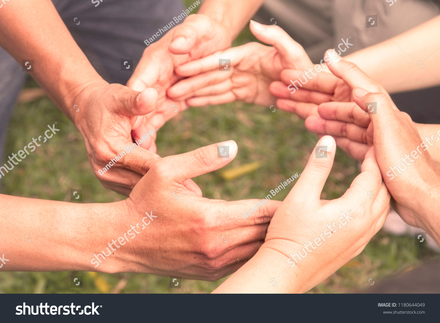 Close-up of people put hands together in circle. Unity concept #1180644049