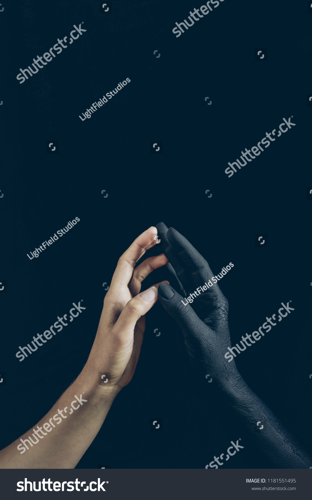 cropped view of woman touching with black demon hand isolated on black #1181551495