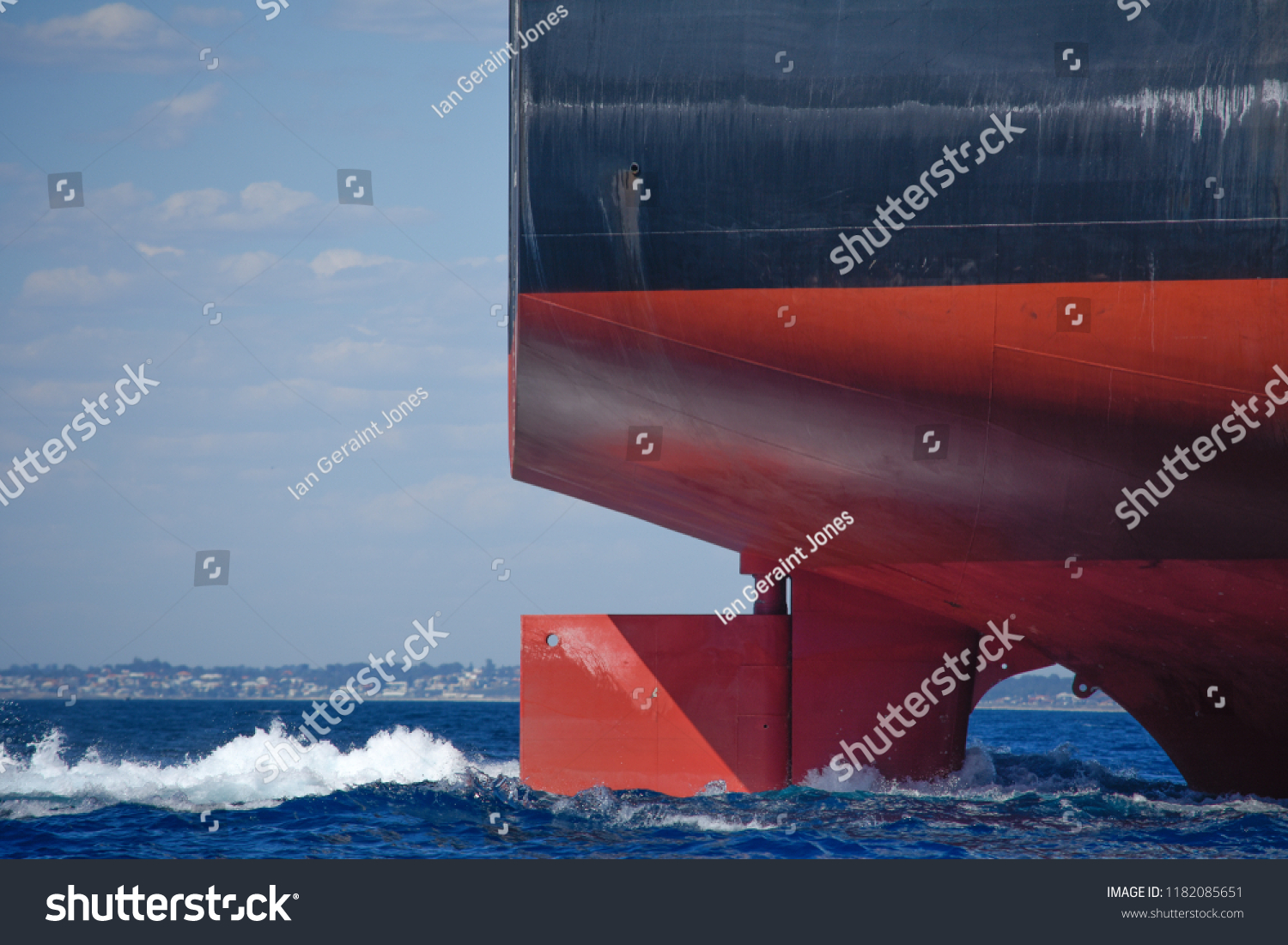 The rudder of a large ship steers it on a steady course #1182085651