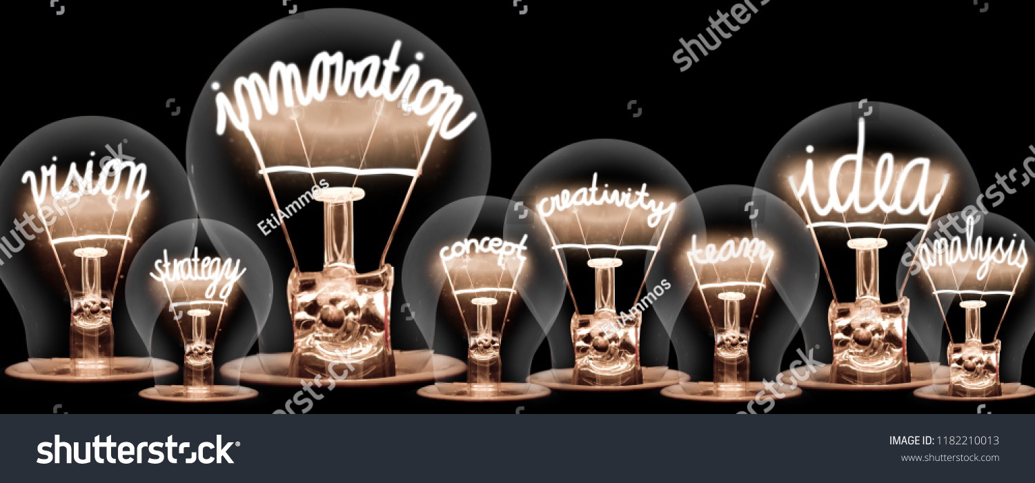 Photo of light bulbs with shining fibres in INNOVATION, IDEA, VISION, CONCEPT and CREATIVITY shape on black background #1182210013
