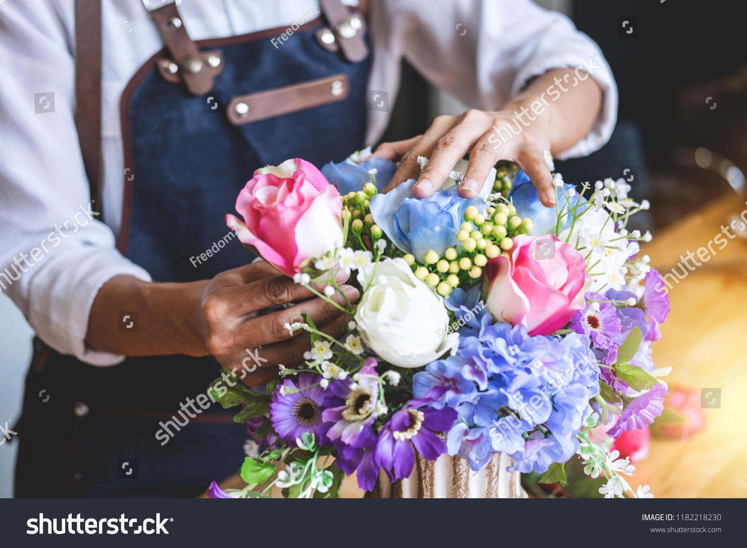 Arranging artificial flowers vest decoration at home, Young woman florist work making organizing diy artificial flower, craft and hand made concept. #1182218230