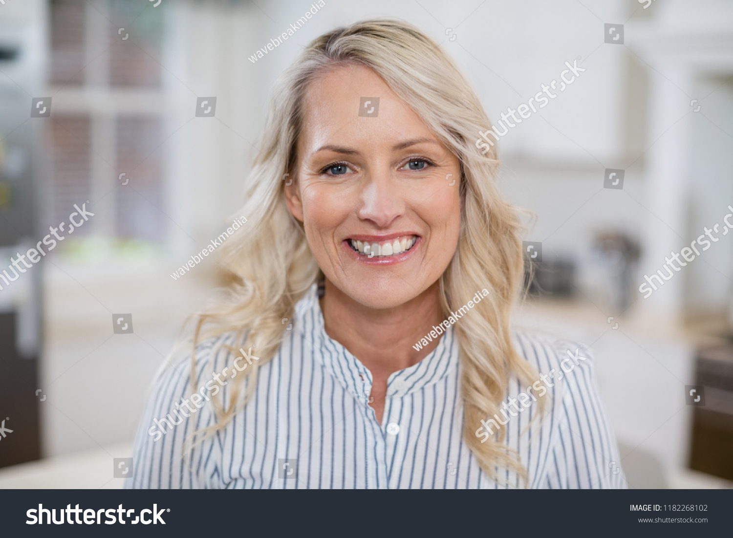 Portrait of beautiful woman smiling at home #1182268102