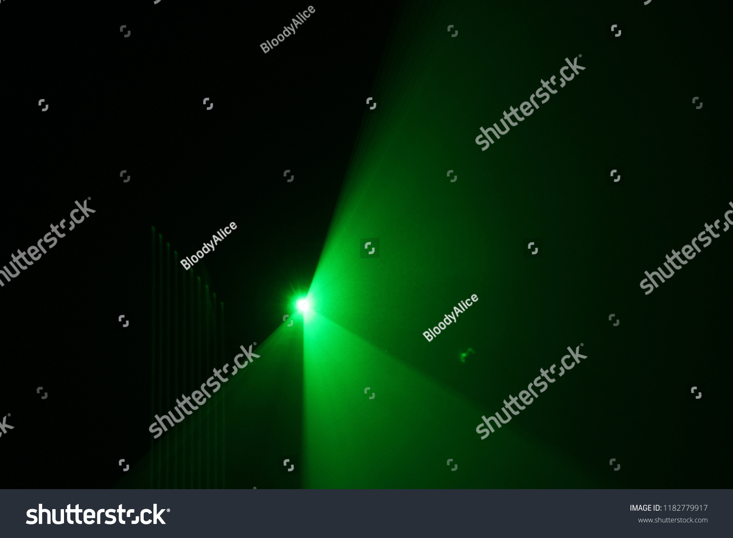 green beam  laser beam on dark background #1182779917