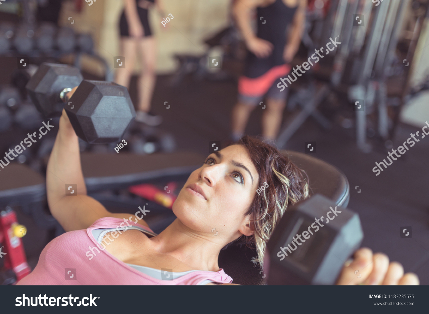 Young sporty woman portrait working out in the gym with dumbbel. Concept of active lifestyle. #1183235575