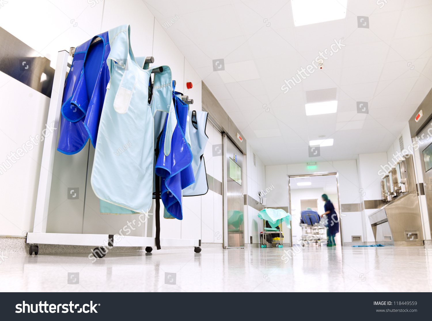 Doctor protective uniforms for surgery hanging in a light hospital corridor #118449559