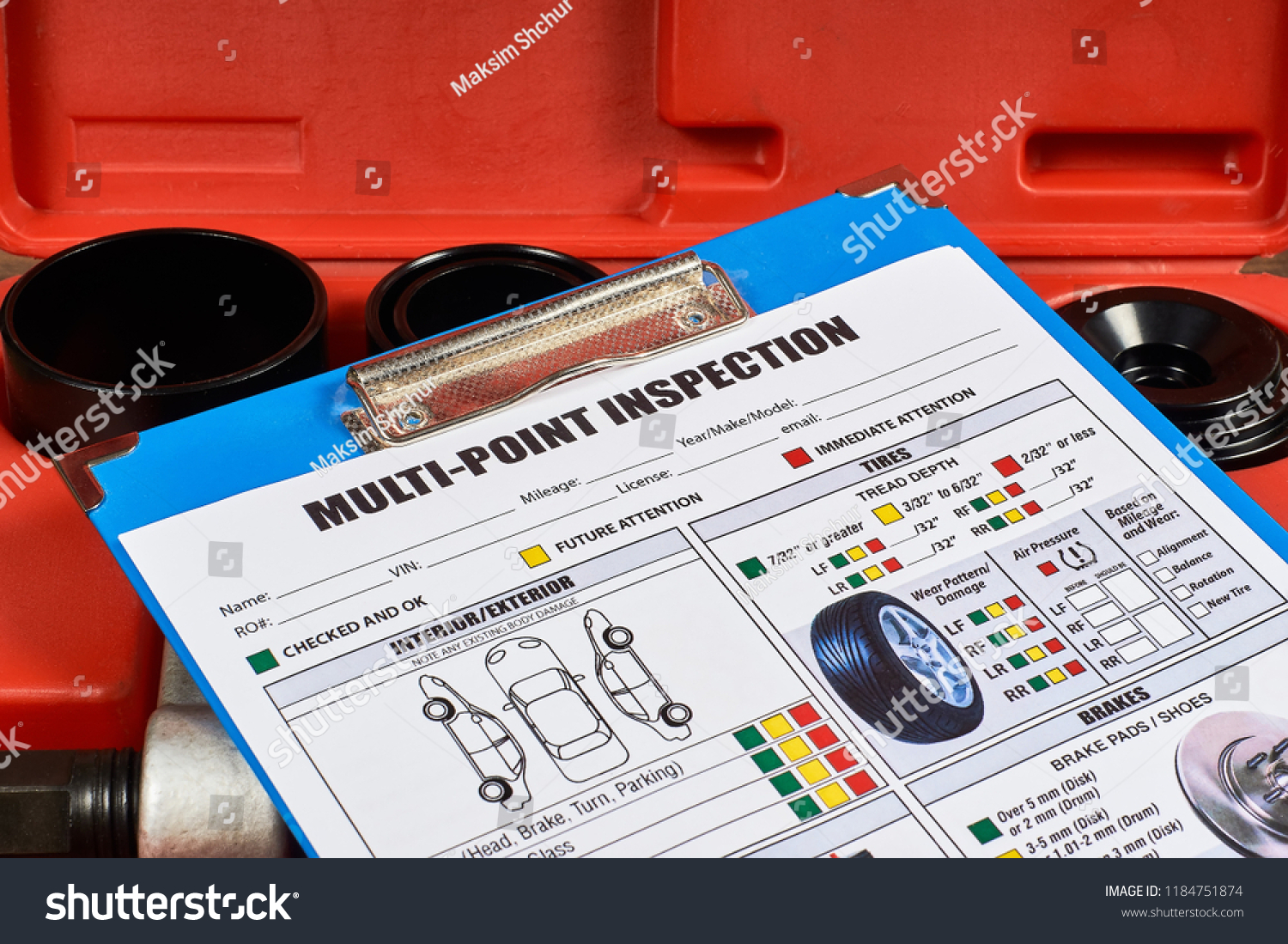 Vehicle multi-point inspection form against the background of automotive tools. Close up. #1184751874