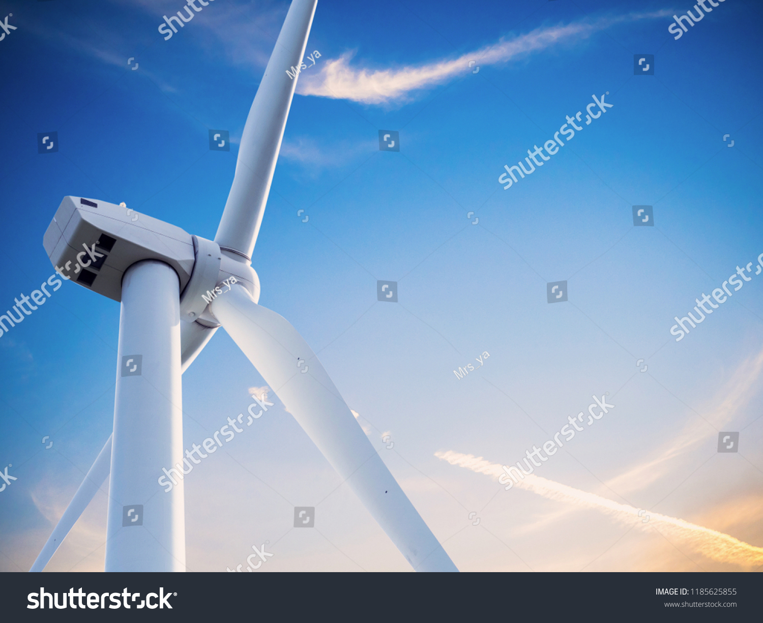 wind mill or also wind-turbine on wind farm in rotation to generate electricity energy on outdoor with sun and blue sky
, conservation and sustainable energy concept. #1185625855