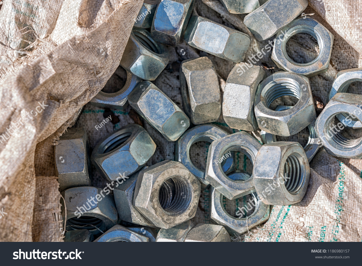 steel nuts with galvanized. A nut is a type of fastener with a threaded hole. Nuts are almost always used in conjunction with a mating bolt to fasten multiple parts together. #1186980157