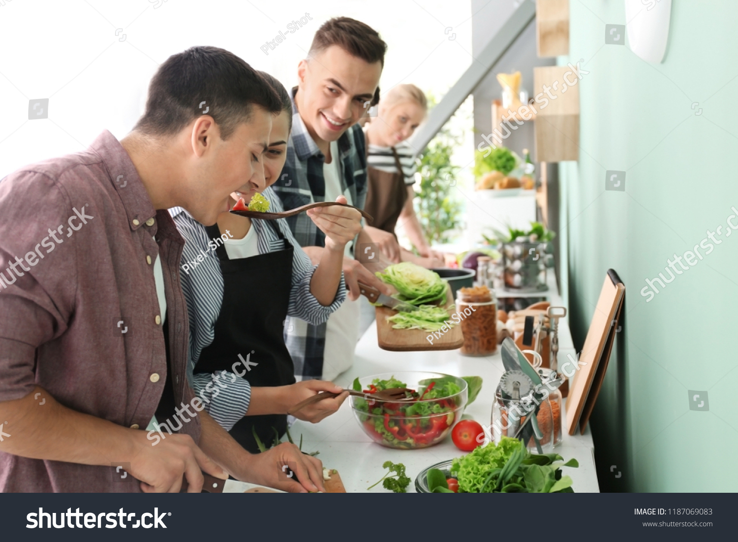 Friends cooking together in kitchen #1187069083
