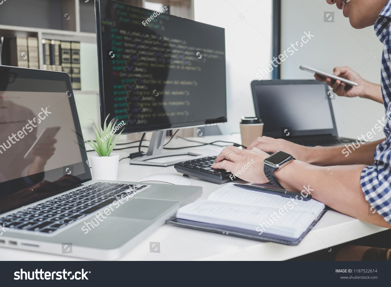 Programmers cooperating at Developing programming and website working in a software develop company office, writing codes and typing data code. #1187522614