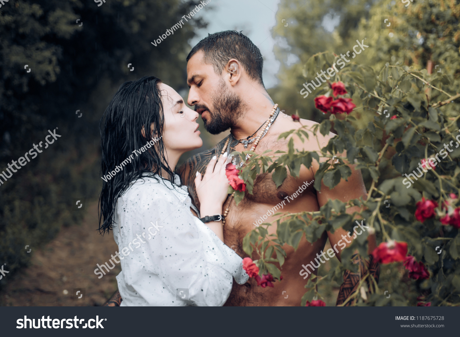 Sensual couple kiss. First love. Hugs together and sensual touch. Intimate relationship and sexual relations. Passionate lover caressing arousing beautiful woman. Woman with muscular latin lover #1187675728