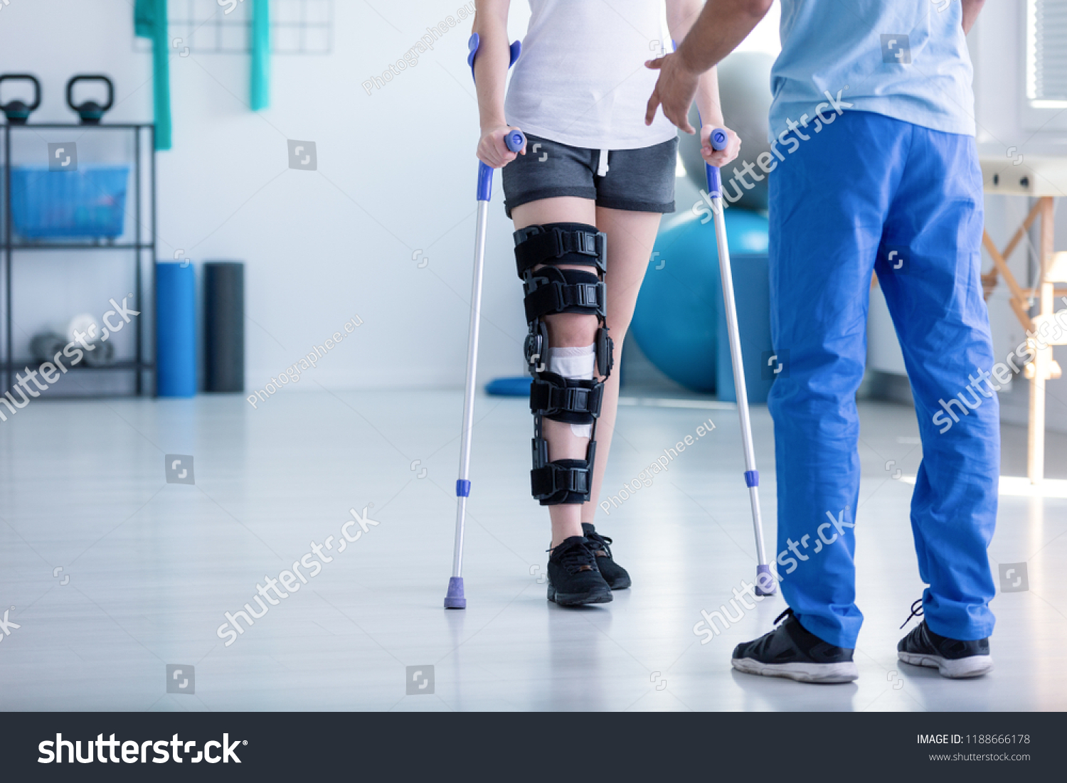 Professional physiotherapist supporting patient with orthopedic problem #1188666178