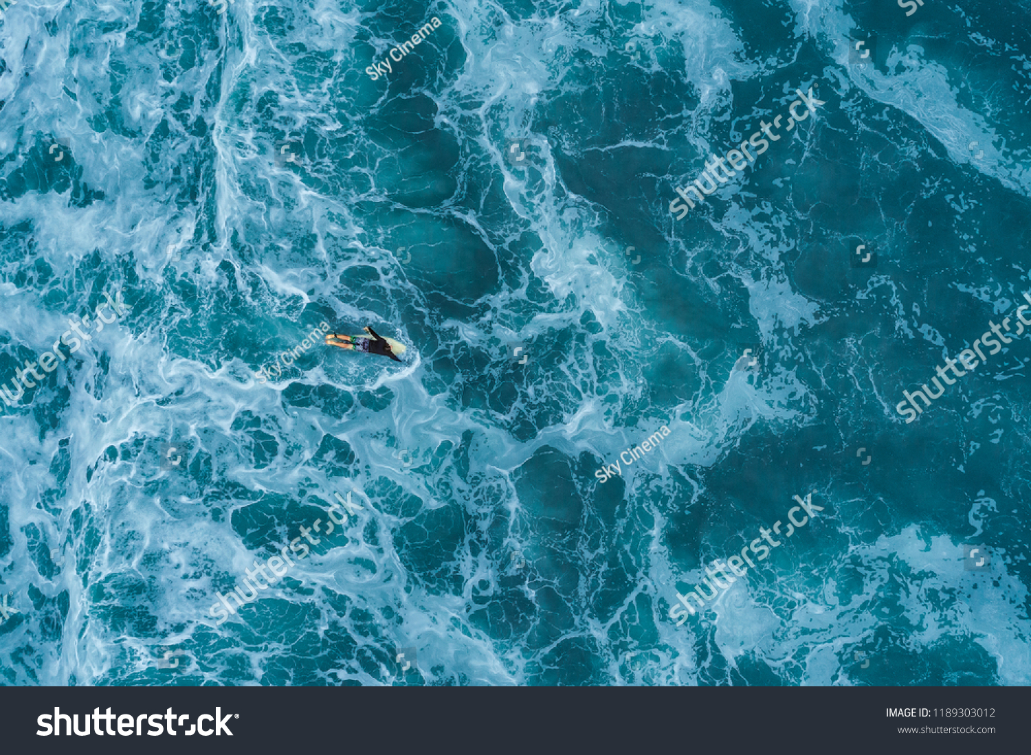 Aerial view of a surfer in the Atlantic Ocean #1189303012