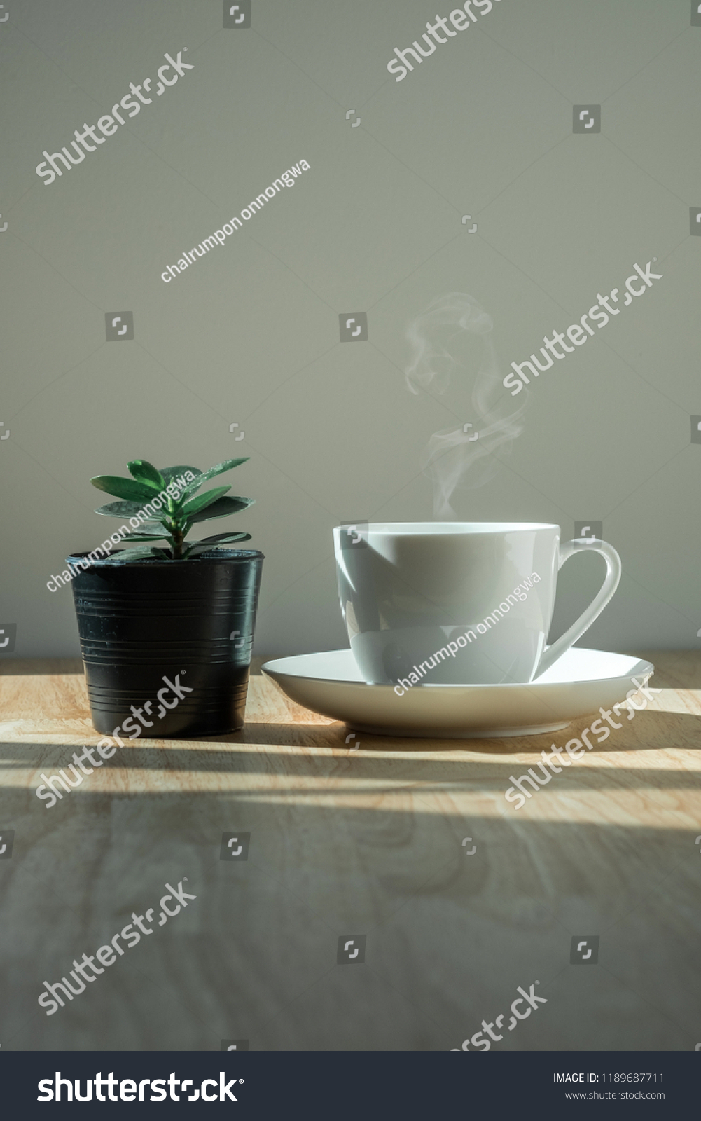 coffee cup on wooden table in the morning light. #1189687711