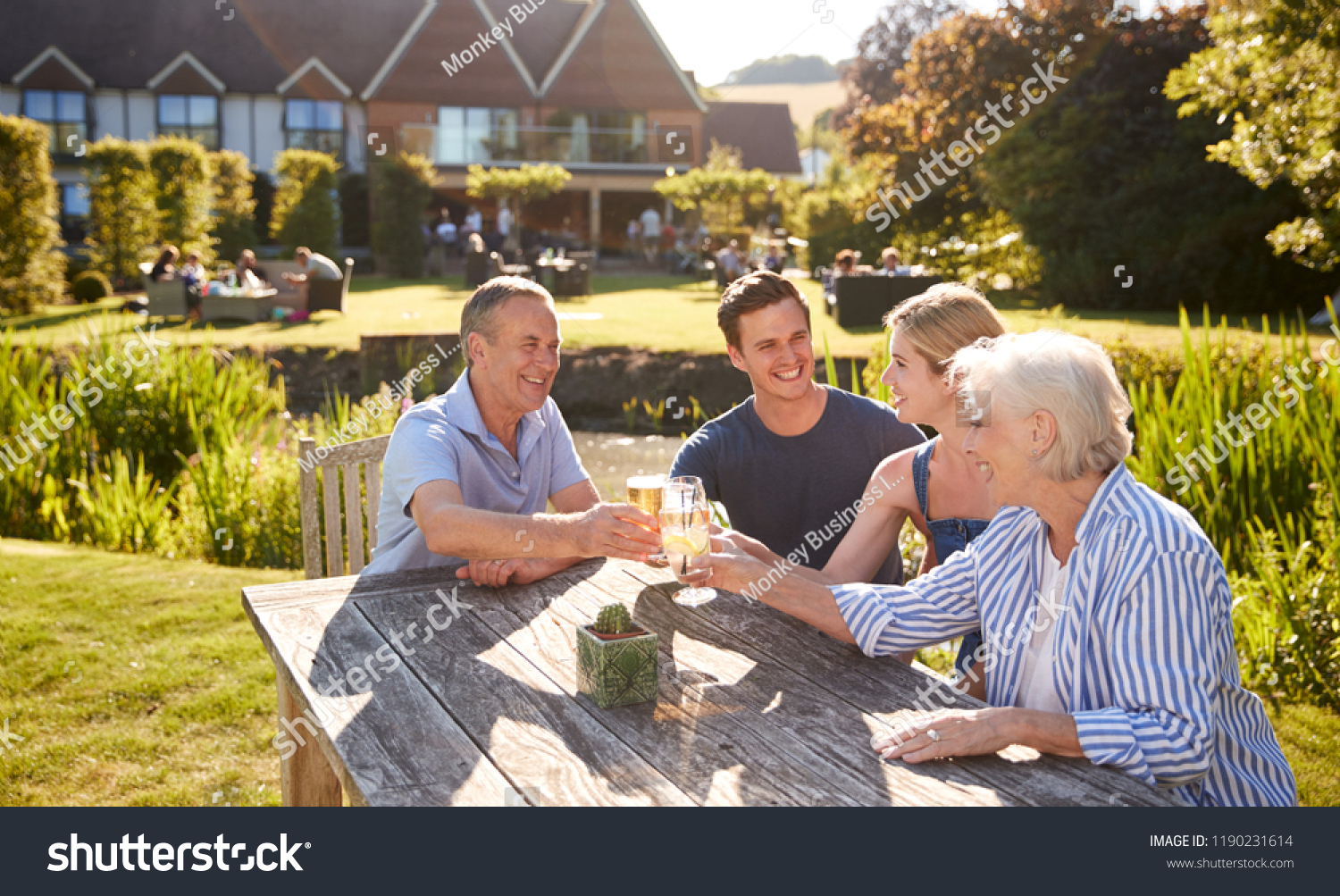 Parents With Adult Offspring Enjoying Outdoor Summer Drink At Pub #1190231614