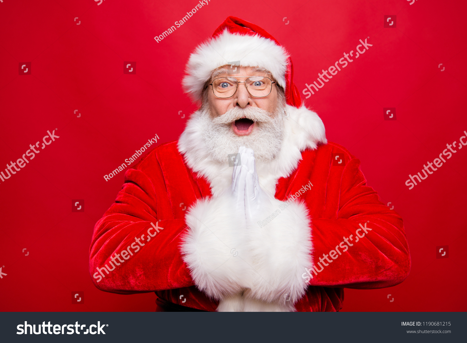 Reaction emotions concept. Impressed aged stylish Santa in spectacles open mouth staring eyes expressing face white beard clapped in hands have incredible news isolated on vivid red background #1190681215