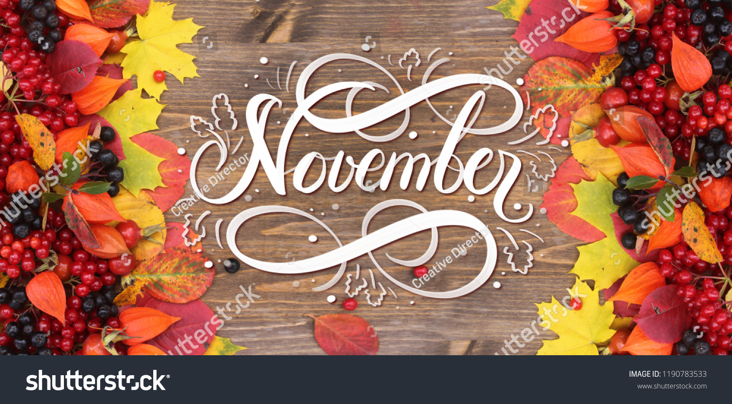 November hand lettering inscription. Bright red autumn leaves and berries frame composition on old wooden background. Great season texture with fall mood. Nature november background.  #1190783533