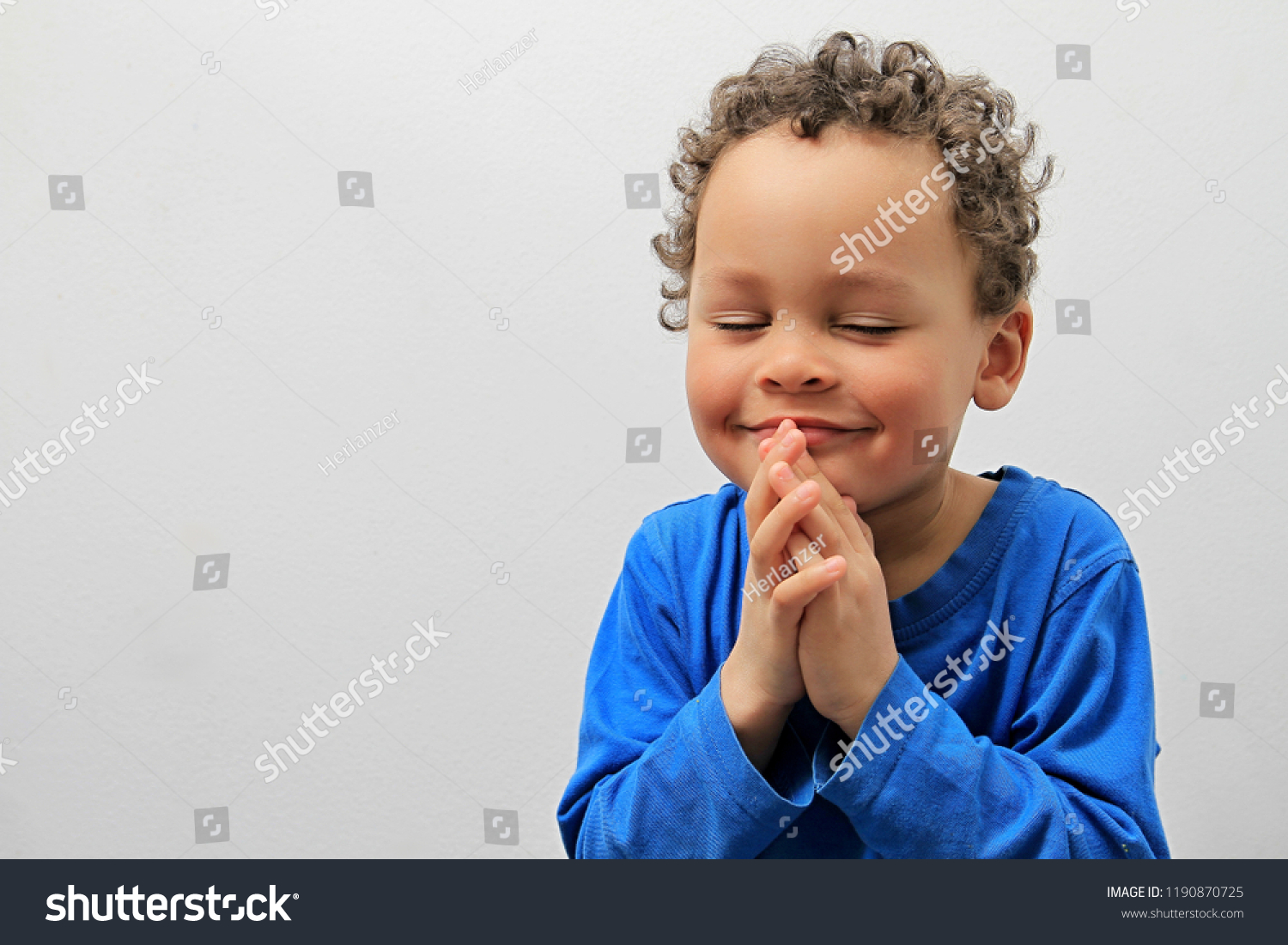 boy praying to god with a smile on his face stock image stock photo #1190870725