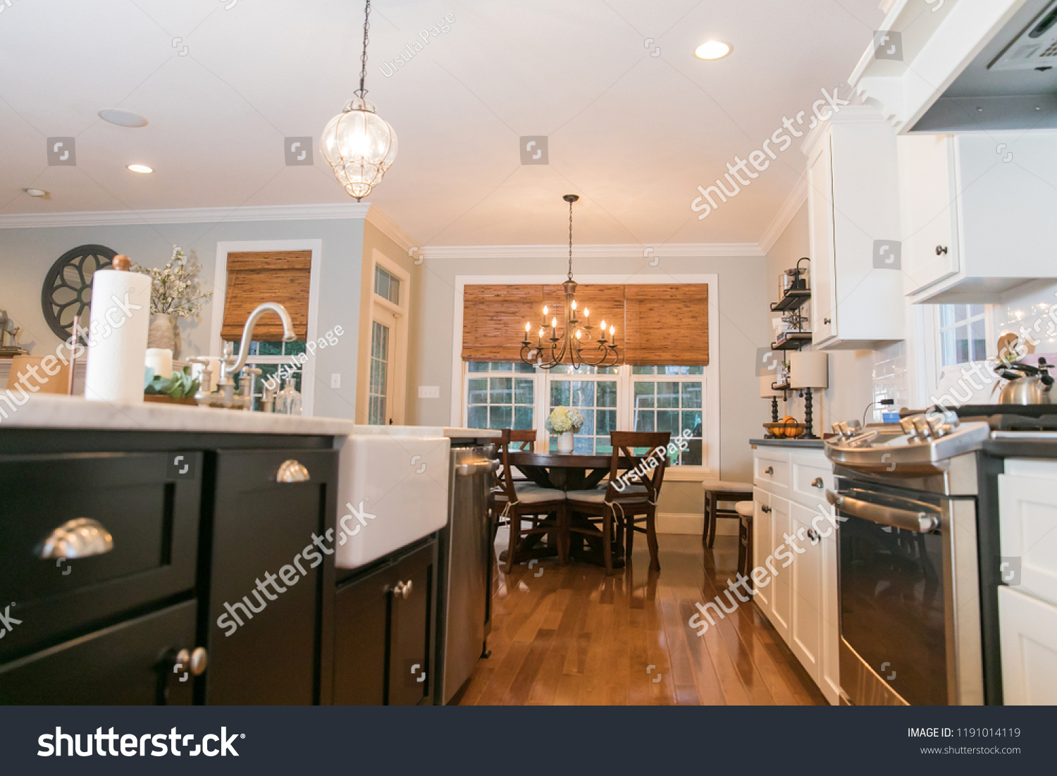 Spacious Modern Kitchen with Dark and White Cabinets Wood Floors Marble Island  #1191014119