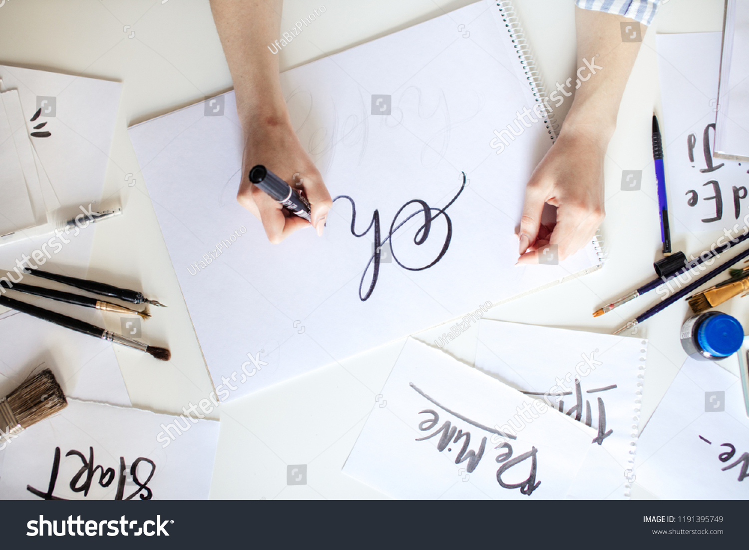 Top view of hand of girl with pen writes on paper with ink #1191395749