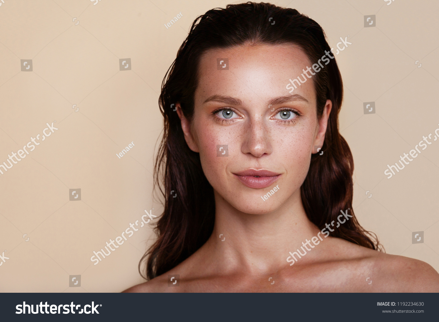 Beauty woman portrait. Beautiful spa model girl with perfect fresh clean skin. Youth and skin care concept. Beige background. Nude makeup #1192234630