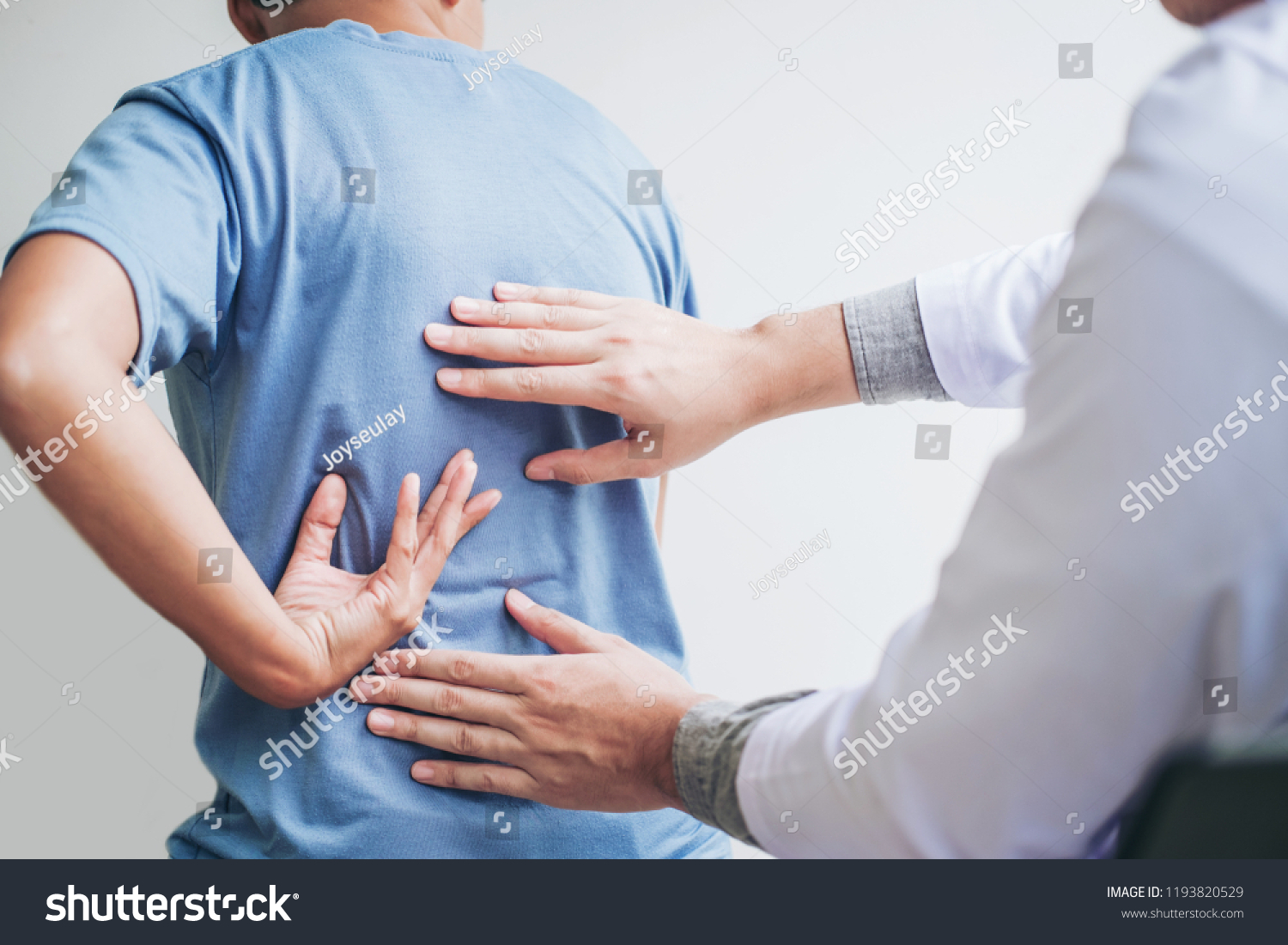 Doctor consulting with patient Back problems Physical therapy concept #1193820529