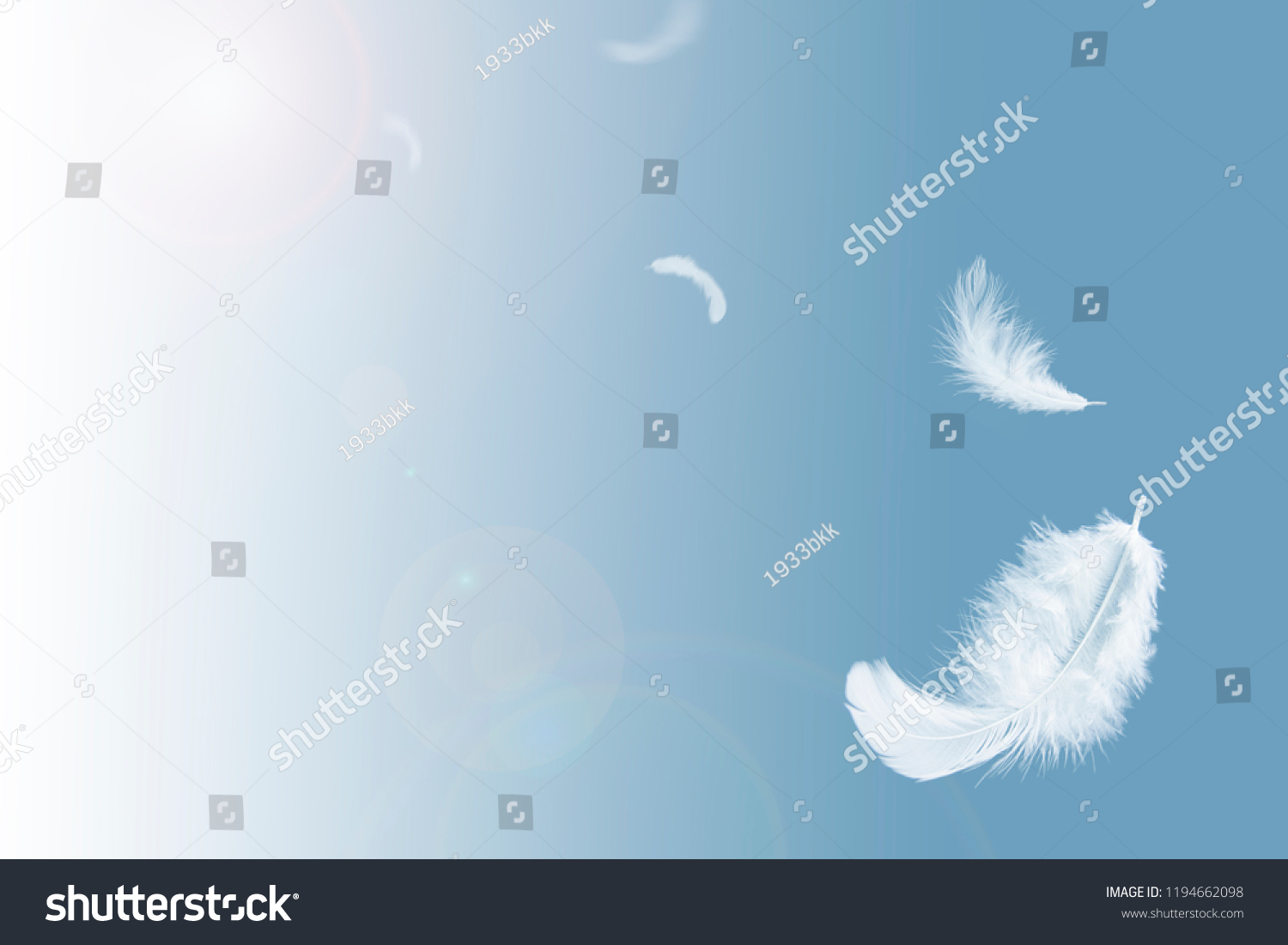 Abstract white feathers floating in blue sky. #1194662098
