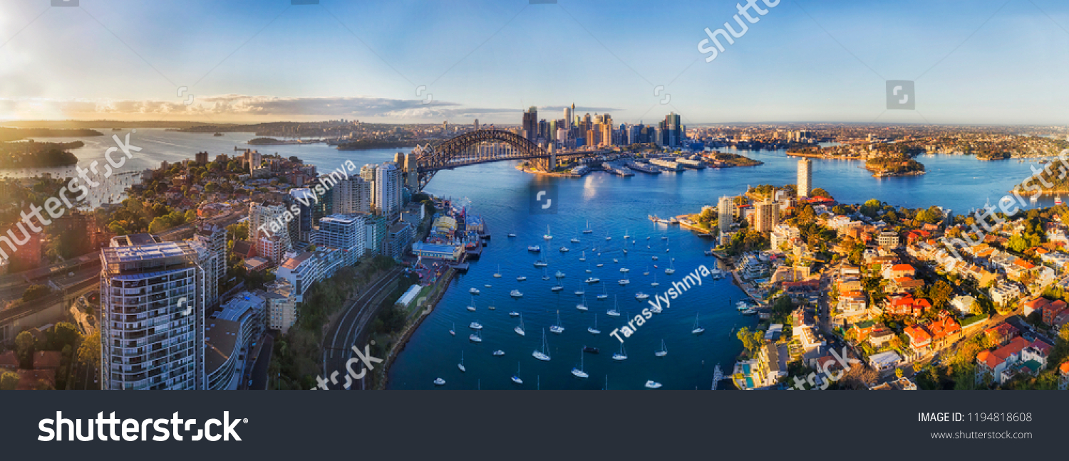 Soft sunlight in the morning over Sydney city CBD landmarks around Harbour and Lavender bay from Lower North SHore along Sydney Harbour bridge and The Rocks with Barangaroo. #1194818608