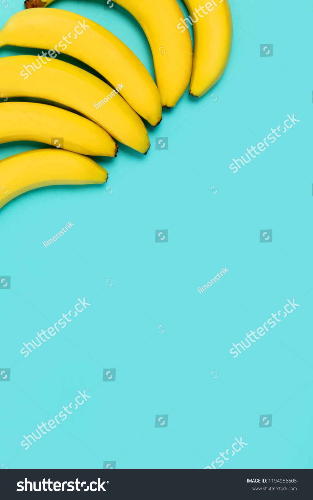 Beautiful yellow bananas on blue colorful background with copy space for text #1194956605