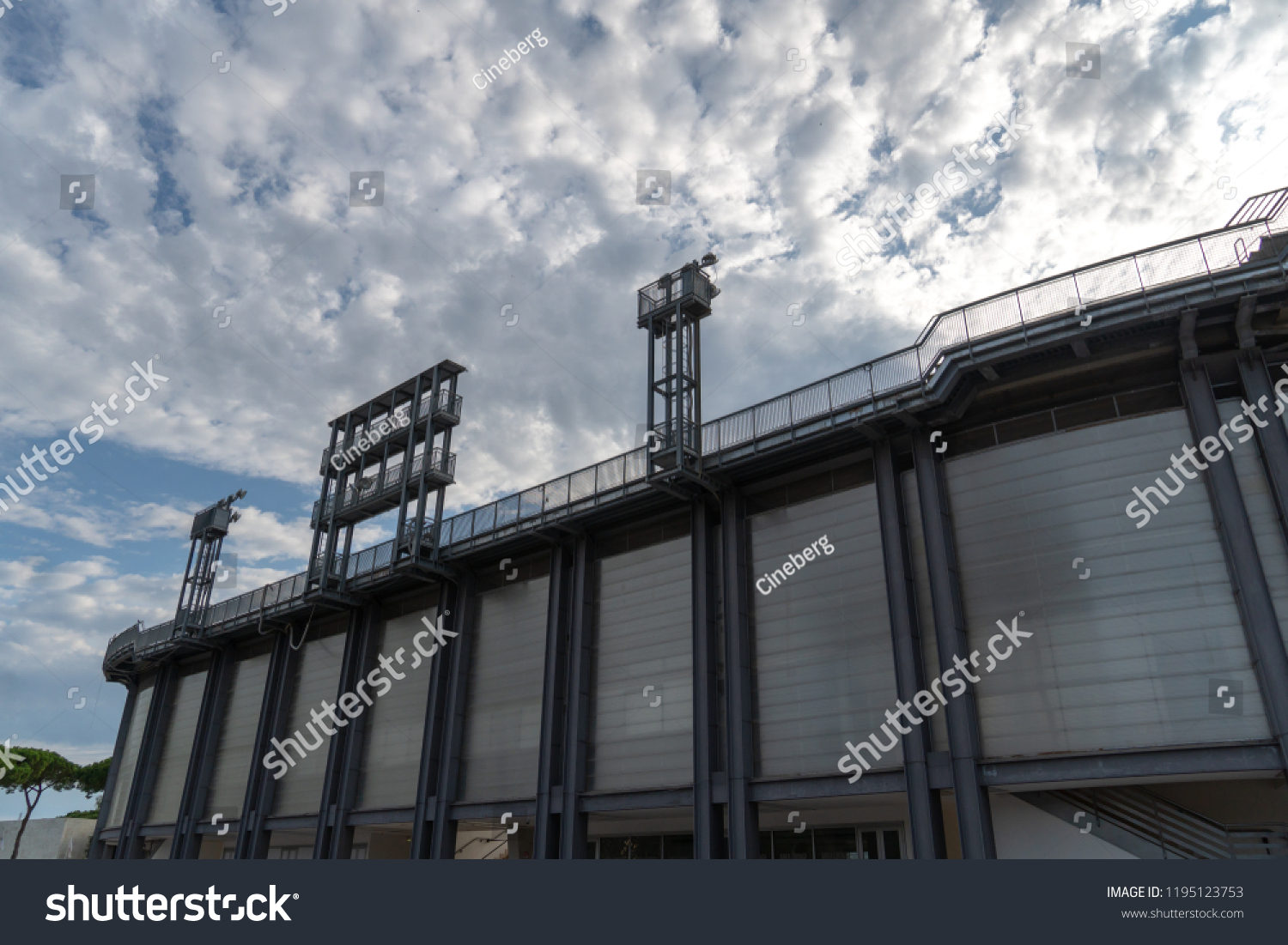 Stadium floodlights against cloudy sky #1195123753